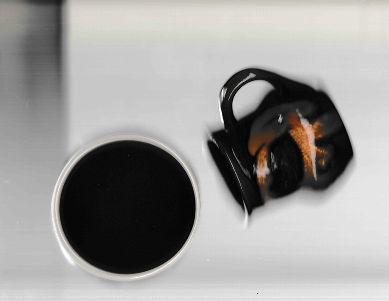 A delft pot, placed mouth down on the scanner platen is orbited by a small tea mug, pointing at an angle towards the black hole of the delft pot.