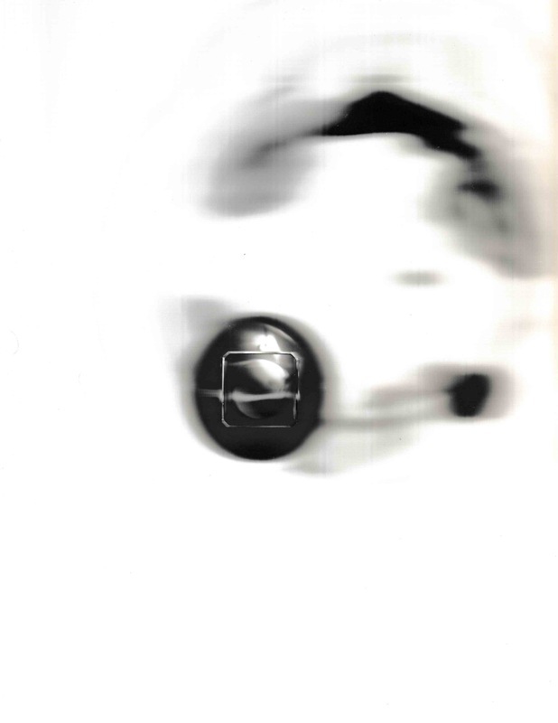 A glass sphere sits on a small square glass stand. The sphere partially occludes a ring of dark shapes. The glass sphere acts as a lens, slightly magnifying the scanner's CIS bar, reflecting a blurred image of my home.