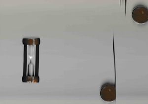 A small hourglass, represented three times. The object was placed at various points on the platen as the CIS bar scanned. On a grey background, this image effectively depicts the scanner's ability to represent objects simultanaeously at various points in time.